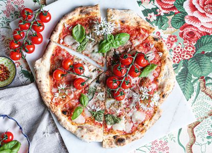 A classic Italian pizza ready to be sliced.