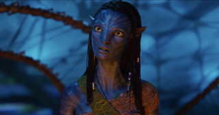 Neytiri (Zoe Saldaña), a Na'vi woman with blue skin and yellow eyes.