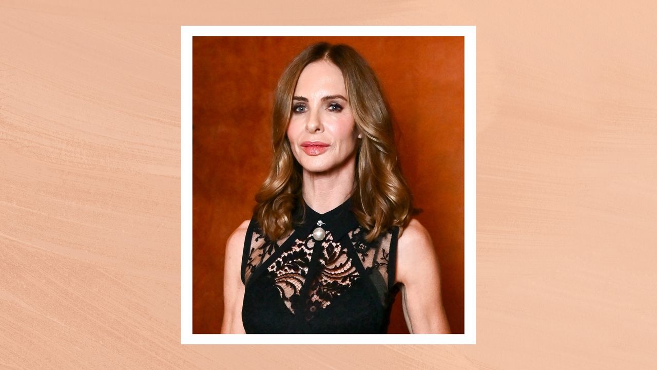 Image of Trinny Woodall with brunette curly hair and wearing a black lace dress