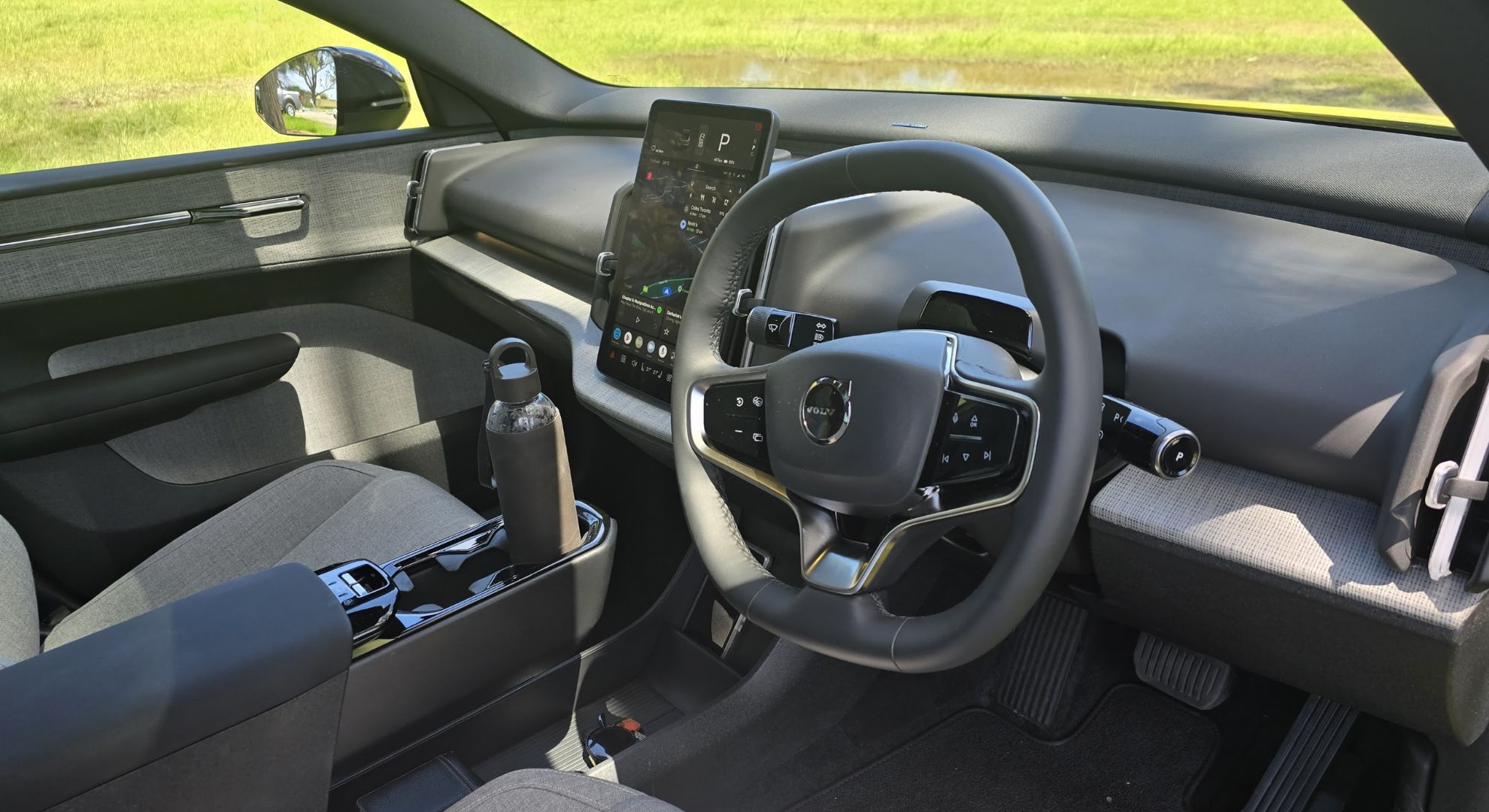 The Volvo EX30's cockpit, showing its infotainment system and steering wheel