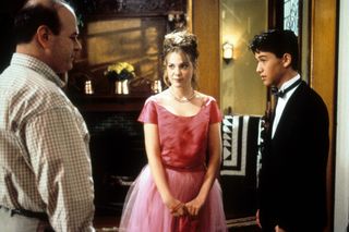 Larry Miller stands before Larisa Oleynik and Joseph Gordon-Levitt in a scene from the film '10 Things I Hate About You', 1999.
