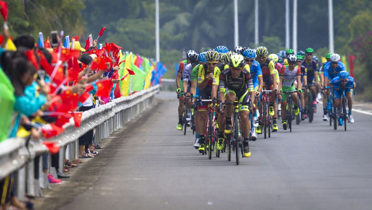 Fans cheer on the riders as they go past