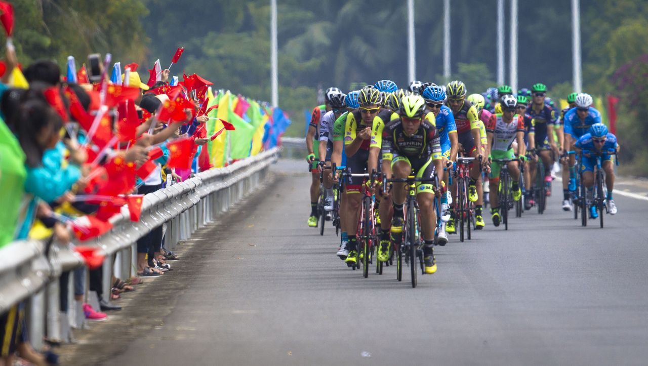 Fans cheer on the riders as they go past
