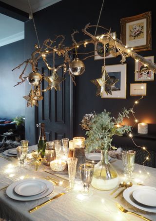 Christmas table centerpiece with decorated branches by Barker & Stonehouse