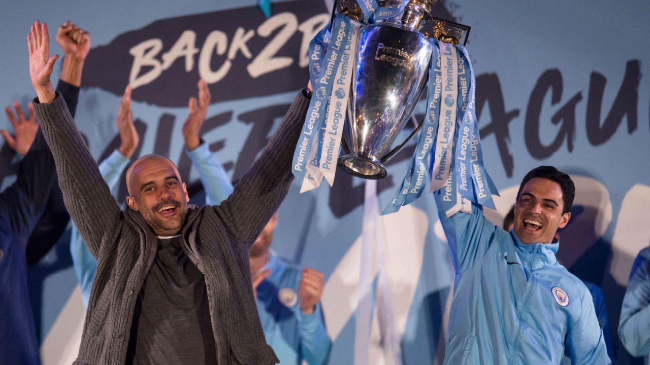 Manchester City manager Pep Guardiola and assistant coach Mikel Arteta celebrate the 2018-19 Premier League title win