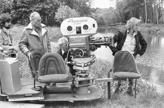 Anthony B Richmond Cinematographer, (left) Director John Sturges (second left) seen here during location filming for The Eagle Has Landed at Mapledurham 14th June 1976