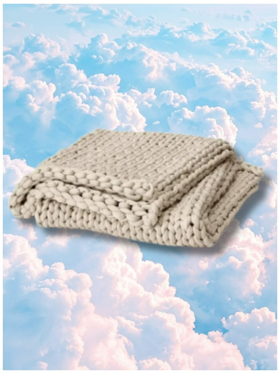 Bearaby, Cooling Weighted Blanket on a dreamy pastel cloud background.