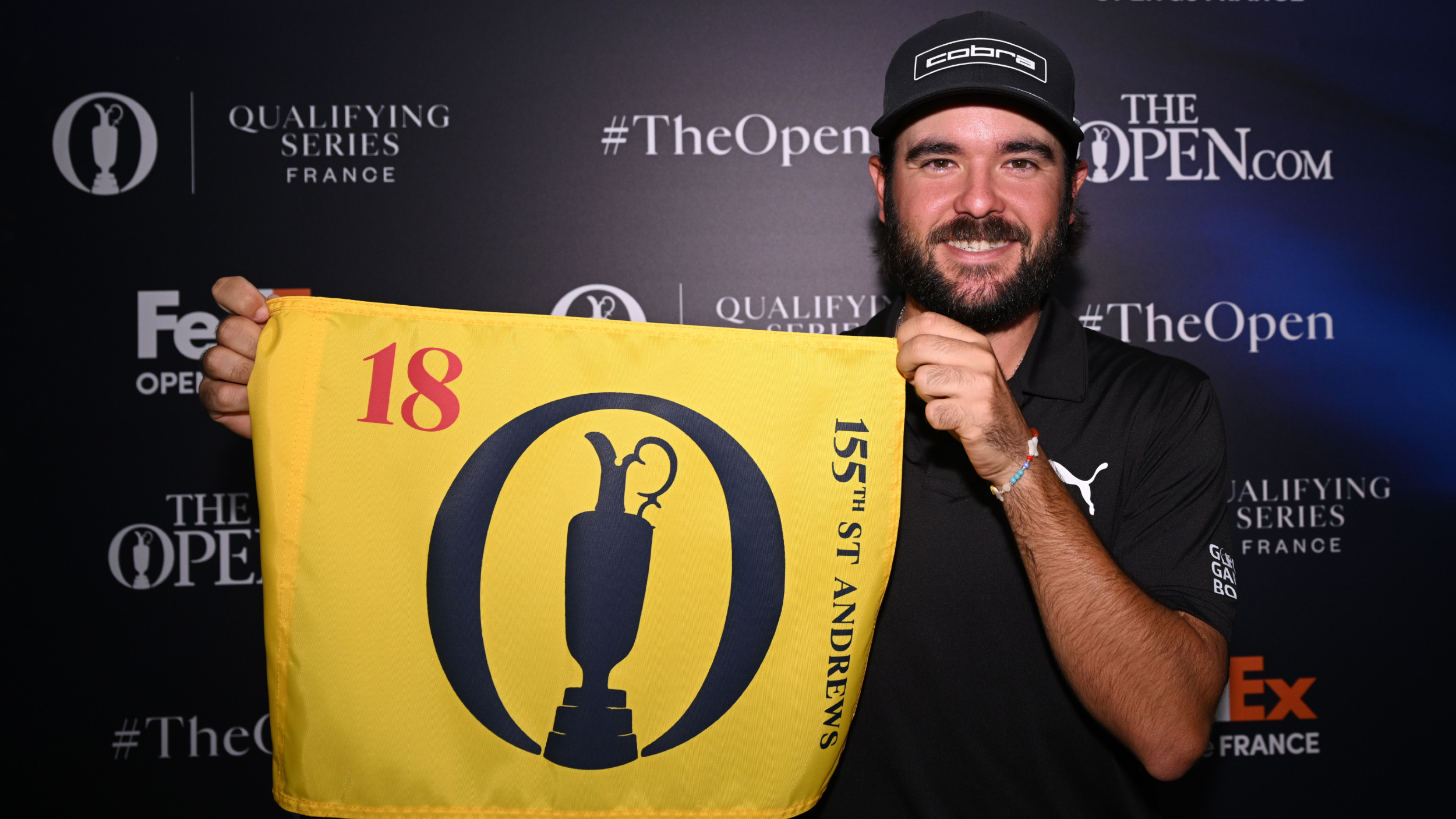 Angel Hidalgo holding an Open flag
