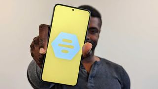 Holding a smartphone with the Bumble logo
