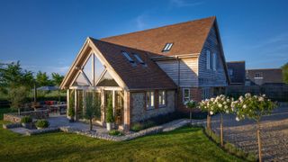 view of oak frame extension added to a house with oak cladding also on exterior of house