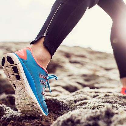 blue pair of running sneakers during a run