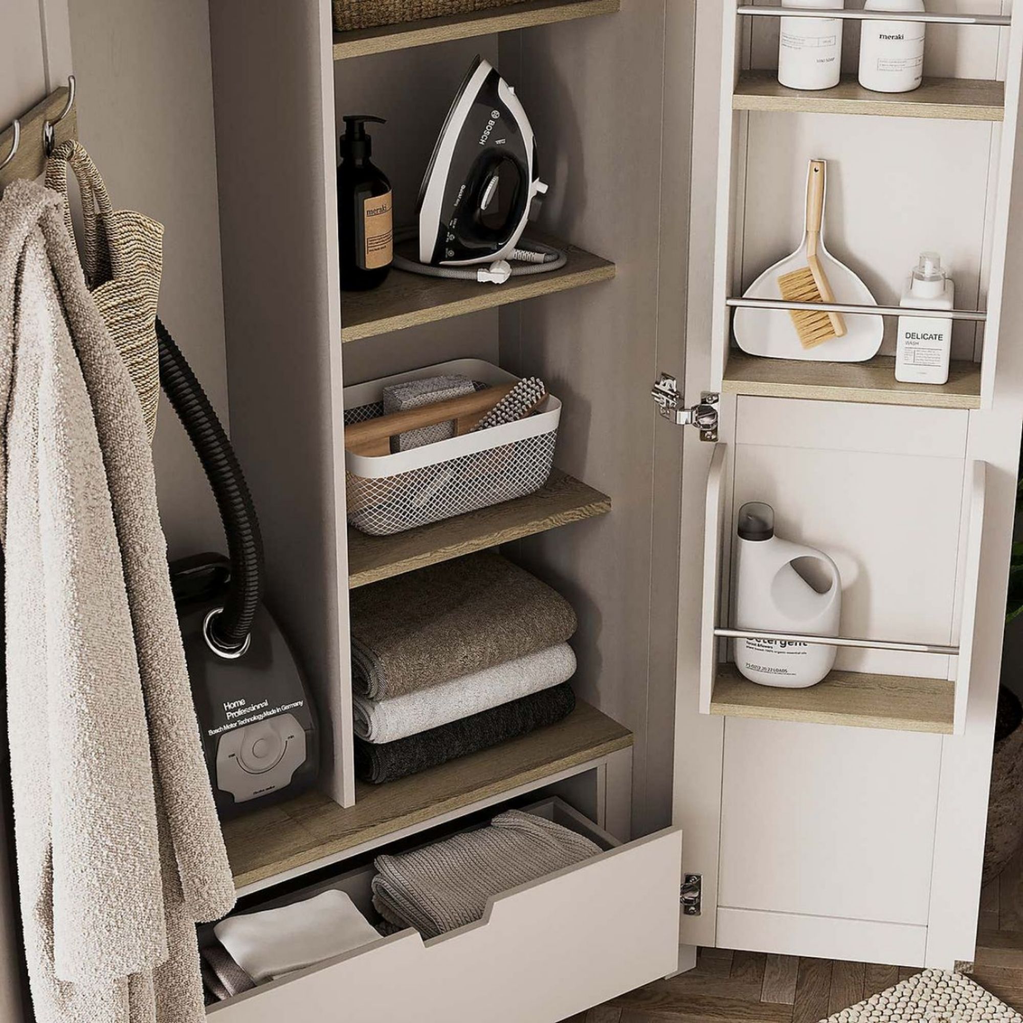 Inside of the Olney Utility Cabinet, showing off blankets, cleaning products and a vacuum cleaner stored inside