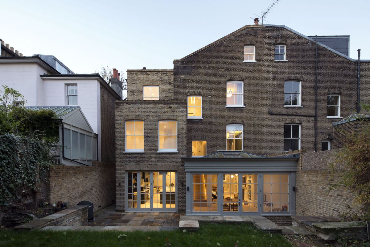 large brick home with traditional conservatory extension