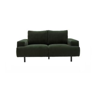 A contemporary dark green velvet sofa with black stiletto legs