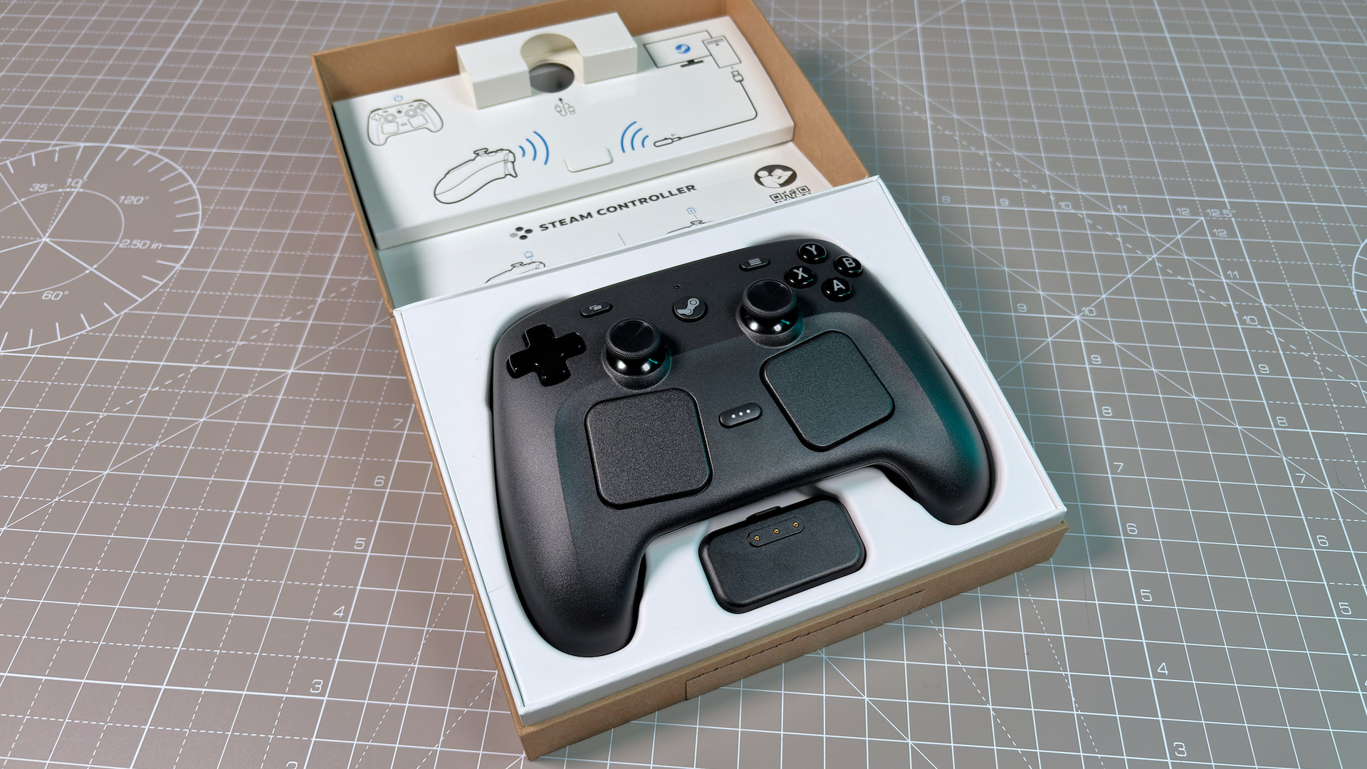 The Steam Controller on a desk during a teardown, with various parts removed.