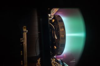A side shot of the X3 ion thruster firing at 50 kilowatts.