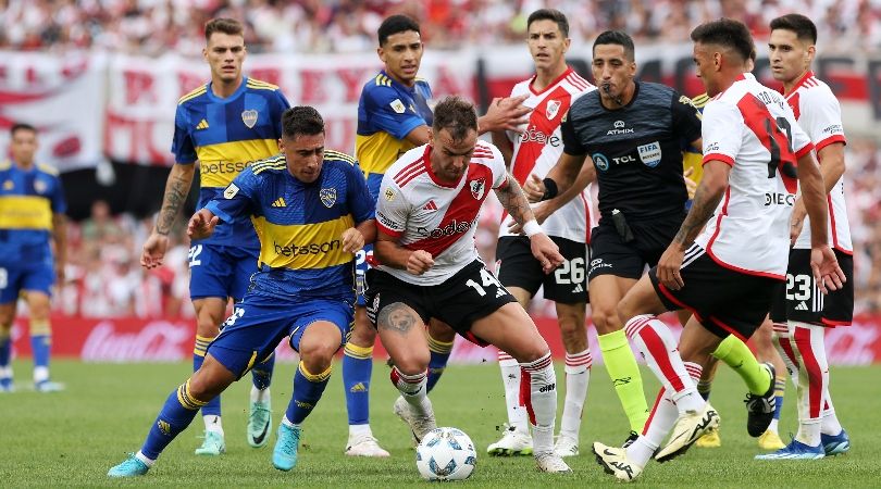 Boca juniors and River Plate players battle for the ball in a match at the Estadio Monumental in February 2024.