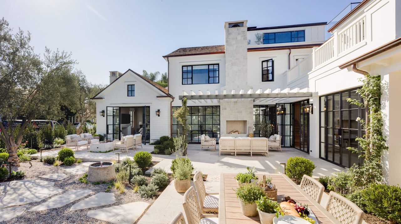 sunny mediterranean style terrace with patio furniture and potted plants