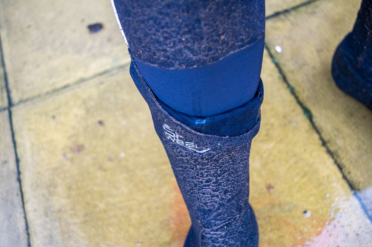 A pair of Spatz overshoes covered in mud and grit after a wet ride
