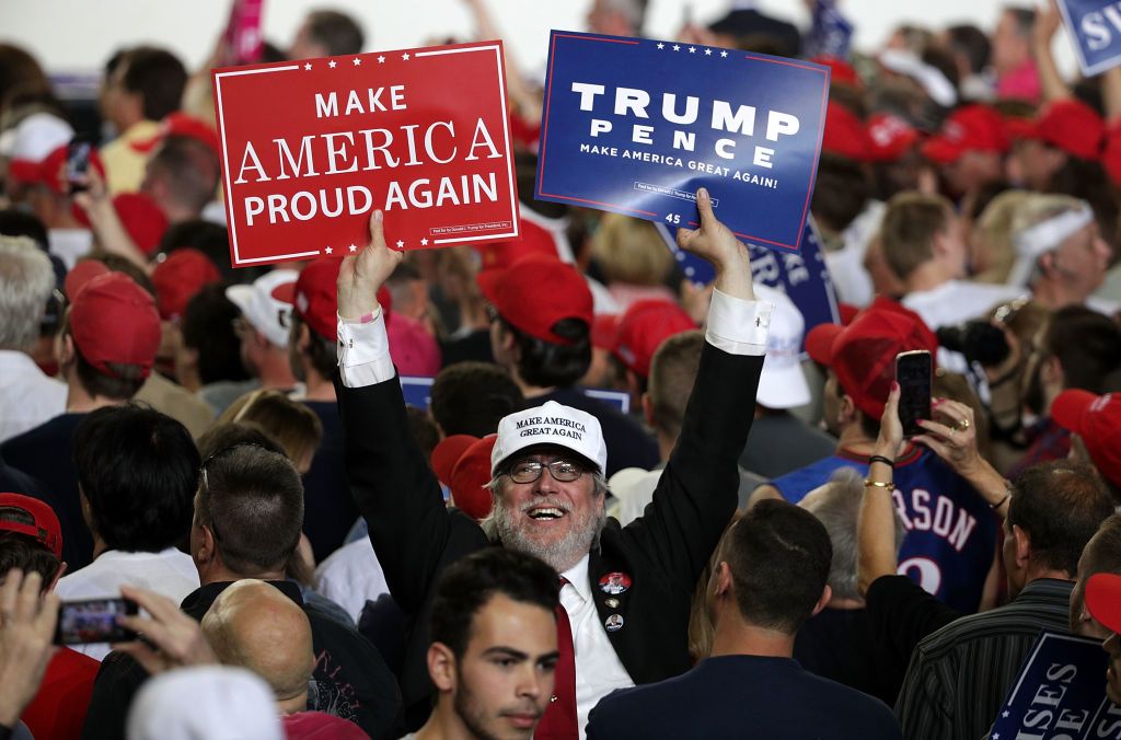 Trump supporter holding signs.