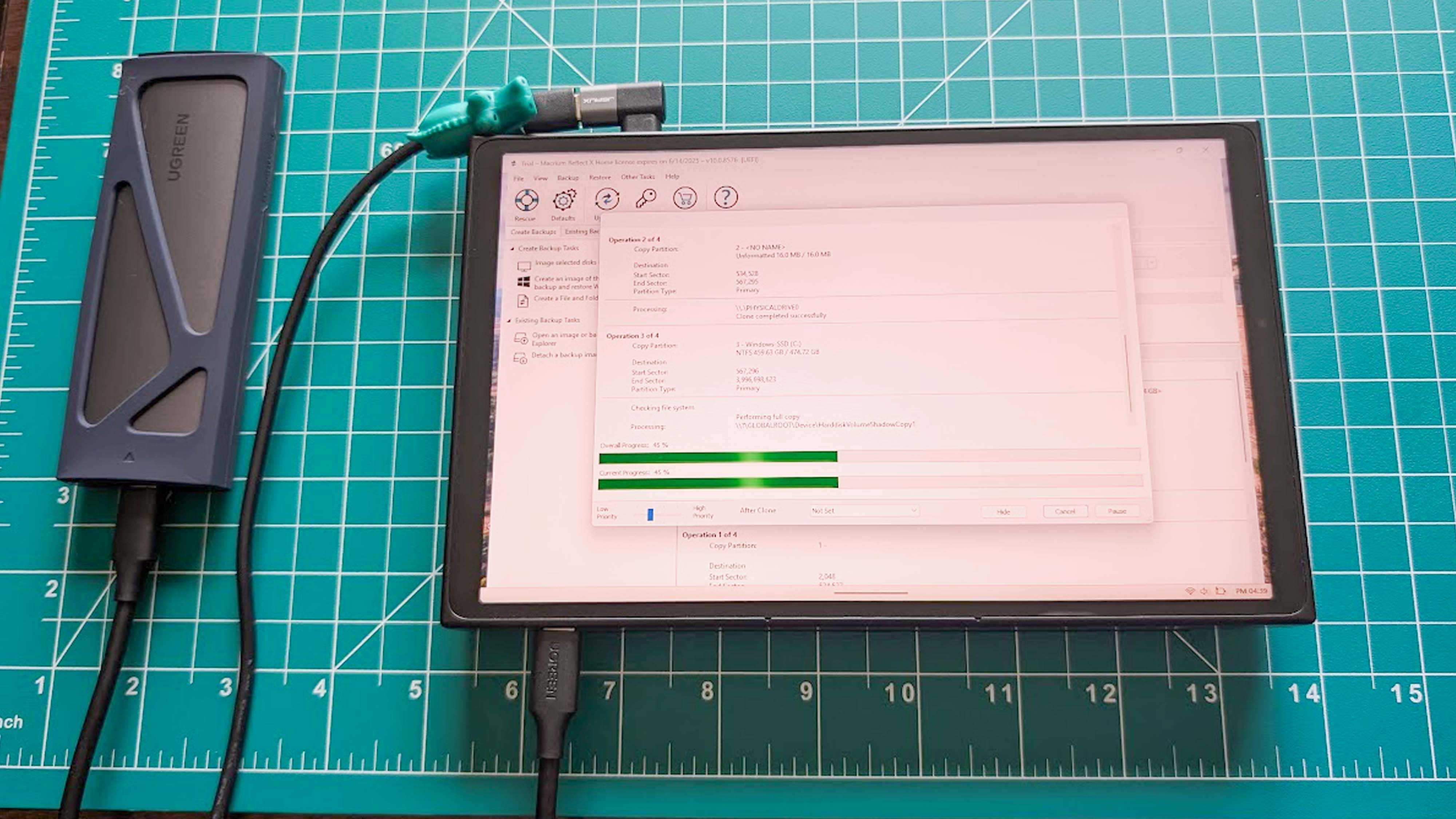 A Lenovo Legion Go connected to an SSD enclosure and cloning the SSD using Macium Reflect.