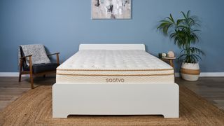 The Saatva Classic mattress in our Sleep Studio, decorated like a bedroom