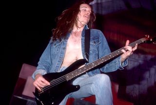A picture of Metallica bassist Cliff Burton performing live in 1986 at Pine Knob Music Theatre in Clarkston, Michigan