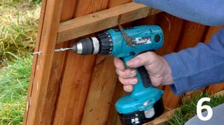Drilling hole in side of fence panel with a cordless drill