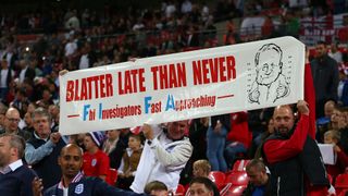 England fans hold up a banner saying - Blatter late than never - in relation to the recent suspension of Sepp Blatter before the UEFA EURO 2016 Qualifier match between England and Estonia at Wembley Stadium on October 9, 2015 in London, United Kingdom. 