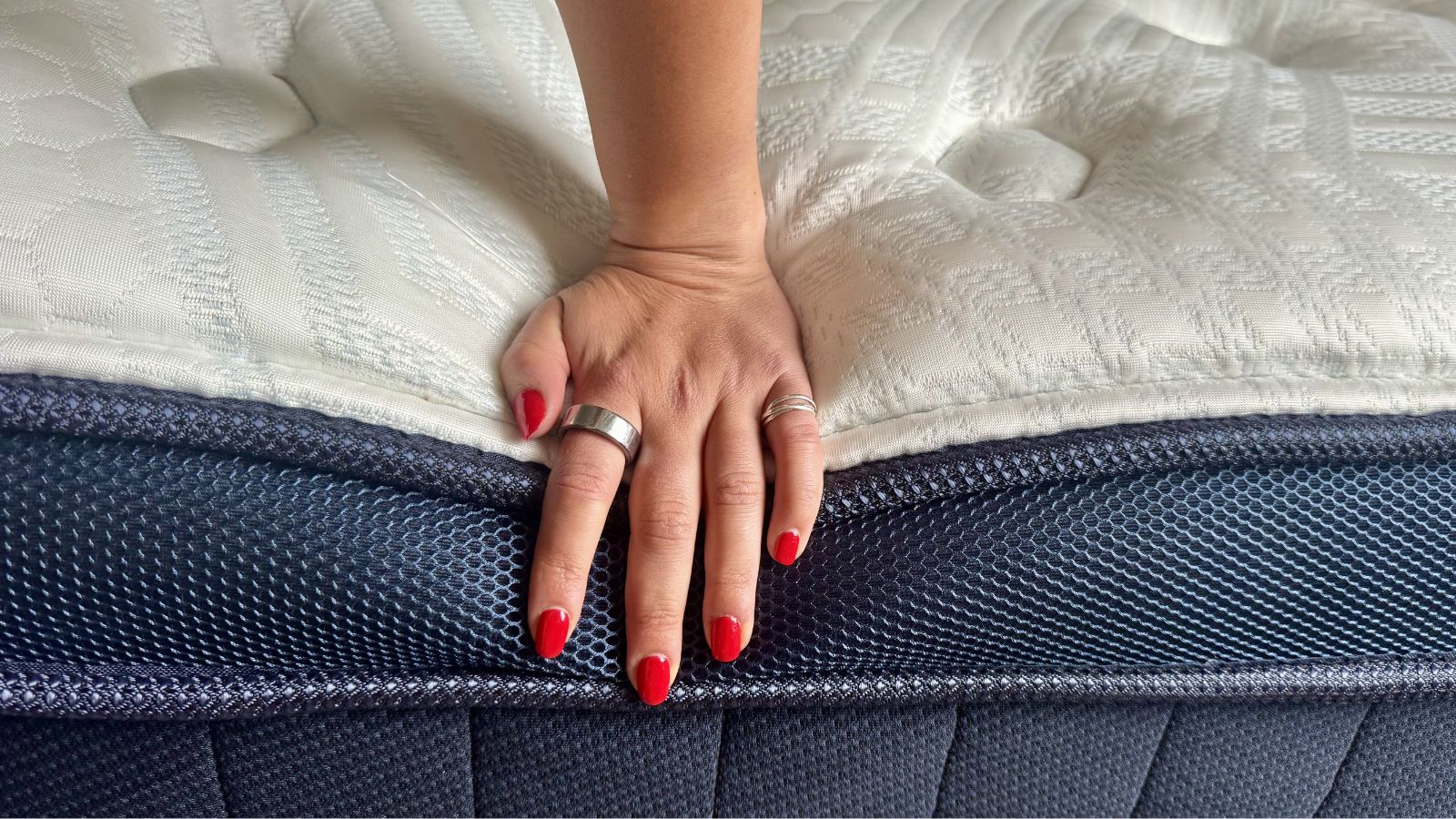 Our mattress tester testing the edge support of the Brooklyn Bedding Thermobalance LX Elite