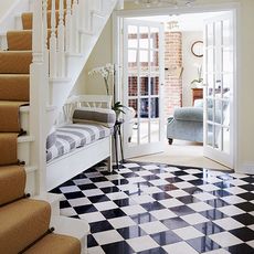 hallway with black and white flooring 