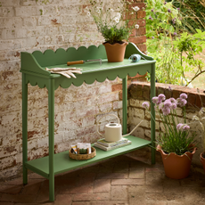 Argos Home green scallop potting table on courtyard.