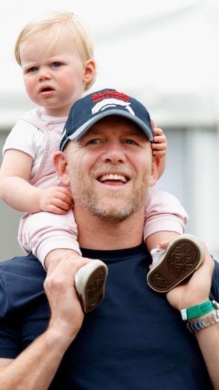 Mike Tindall carries daughter Lena Tindall on his shoulders as they attend day 2 of the 2019 Festival of British Eventing at Gatcombe Park on August 3, 2019 in Stroud, England