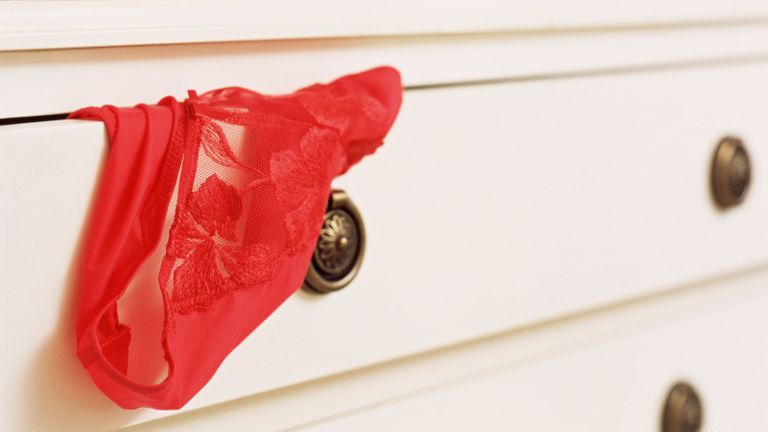 Sexy red lace underwear sticking out of drawer