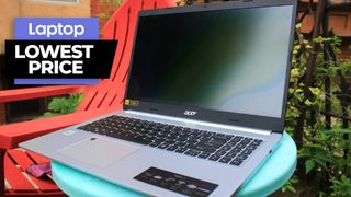 Acer Aspire 5 sitting on a light blue table next to a read chair with a vine in the background 