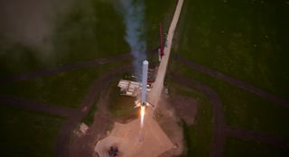 SpaceX's first Falcon 9 Reusable rocket prototype returns toward its launch pad in McGregor, Texas in this still image from an aerial drone video released by SpaceX on April 18, 2014.