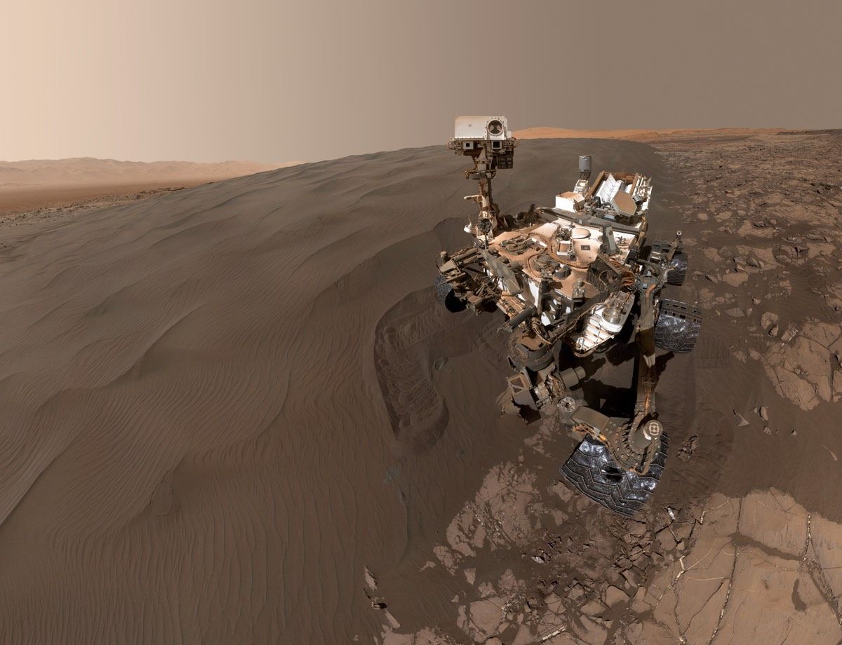 This recent self-portrait from NASA’s Curiosity rover shows the robot shortly after it retrieved a sample of dark sand from shifting dunes along the flank of a Martian hillside.