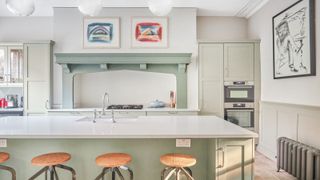 sage green kitchen cabinets with pale grey walls and white marble countertops Gemini Worktops