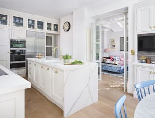 white marble kitchen with open plan living and dining areas