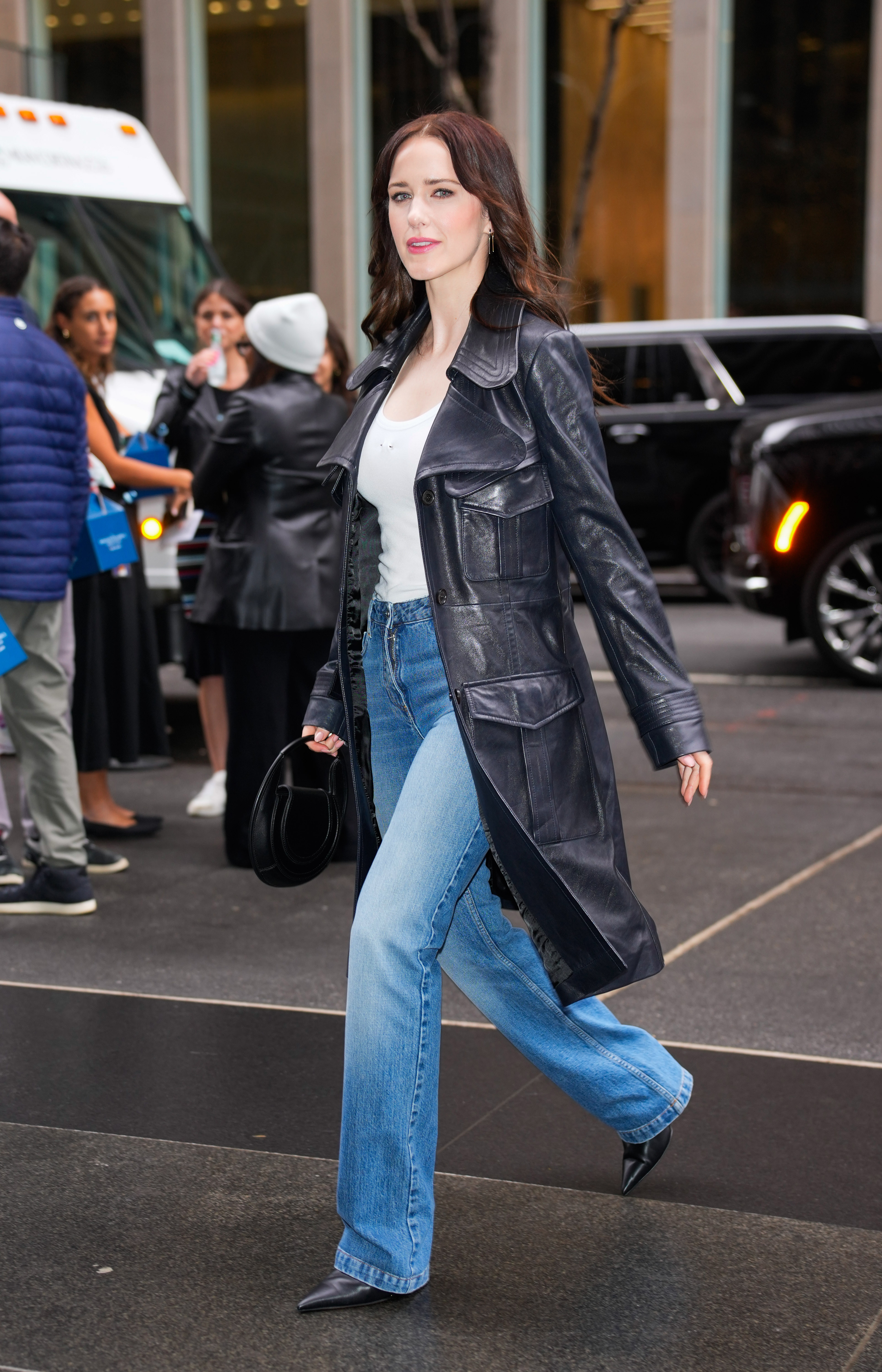 celebrities wearing bootcut jeans with a trench coat and heels