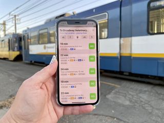 Maps App Transit feature on iPhone 12 with a train in the background