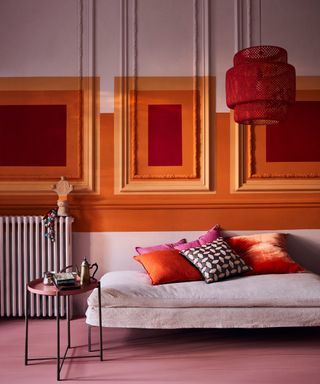 A bold living room with pink, orange and red wall decor using chalk paint by Annie Sloan in shades Antoinette, Barcelona Orange and Emperor's Silk