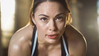 Close-up of woman's face covered in sweat