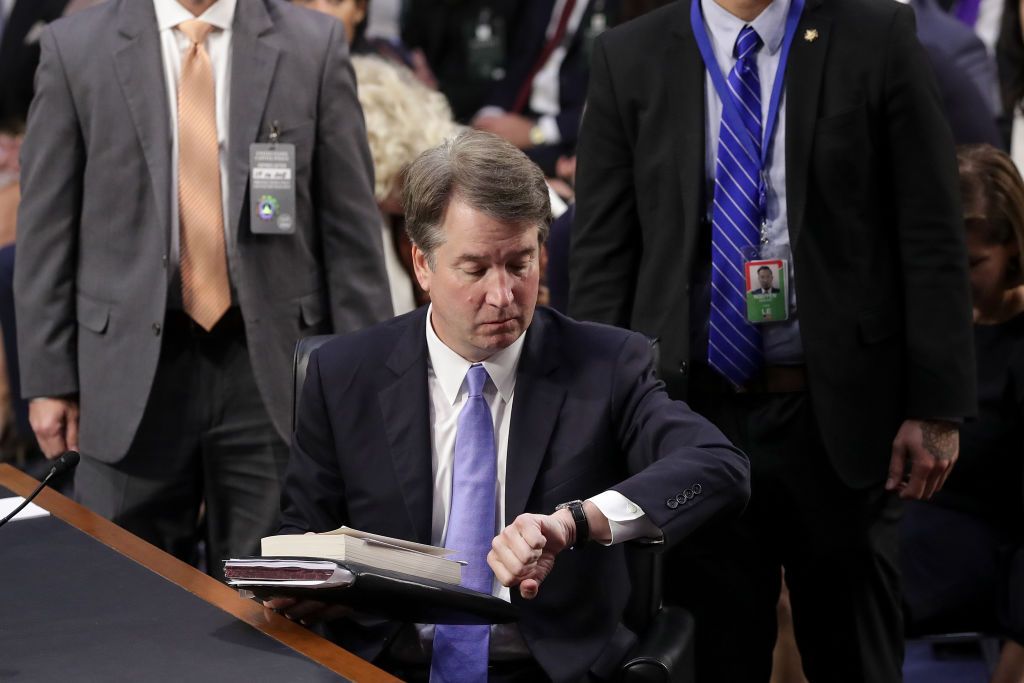 Brett Kavanaugh checks the time