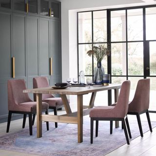 A dining room with a rectangular dining table and upholstered chairs