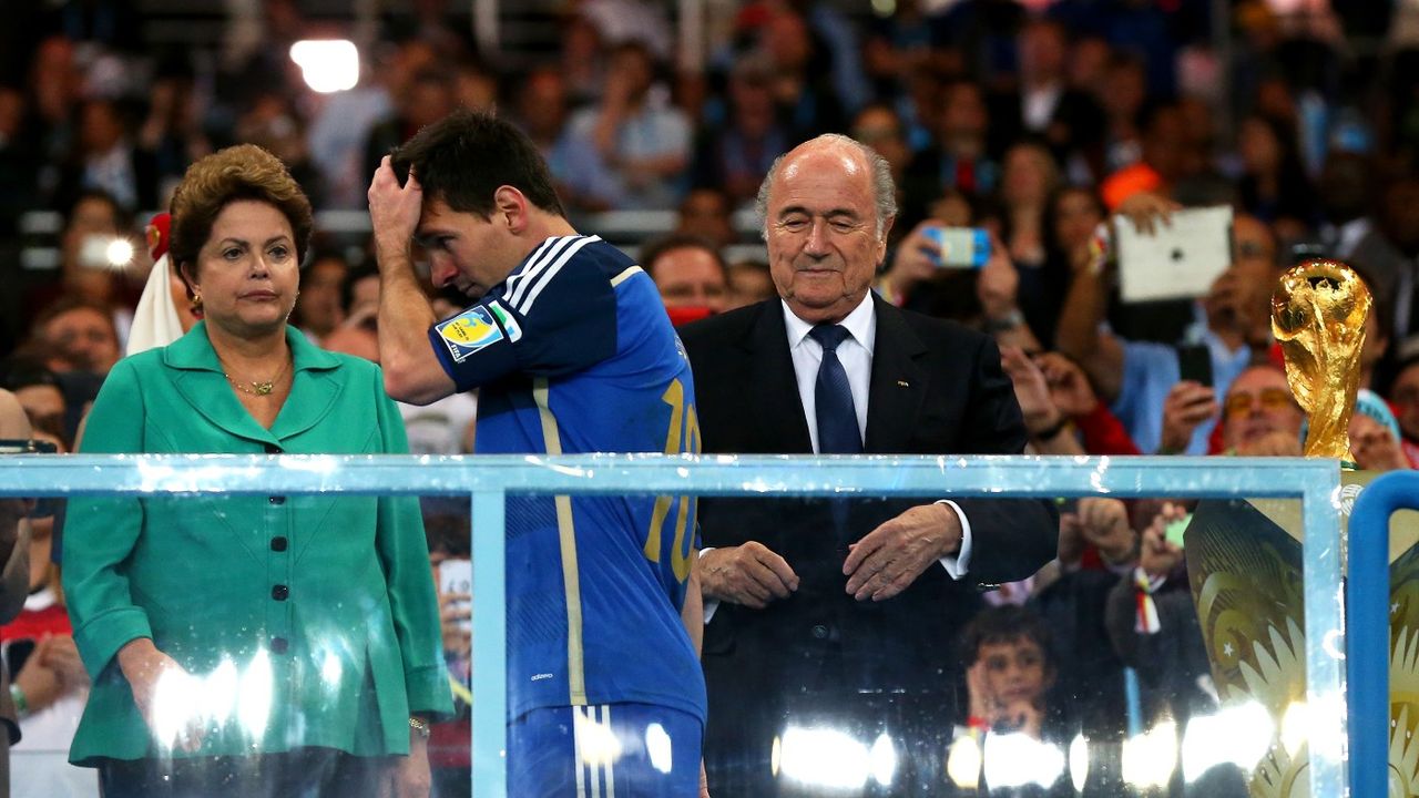 Lionel Messi walks past the World Cup trophy after Argentina lost to Germany in the 2014 final 