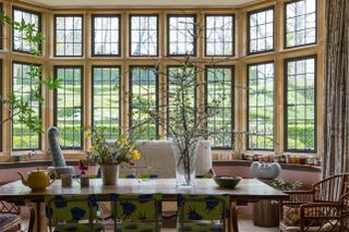 table in bay window with contemporary chairs and sculptures by Anthony Turner