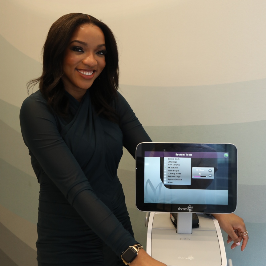 a black woman in a black jumpsuit and Apple watch