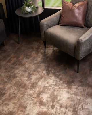 Metallic Bronze flooring with a light brown suede armchair