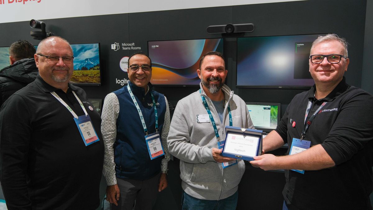 Logitech and Lightware employees connect at a trade show. 